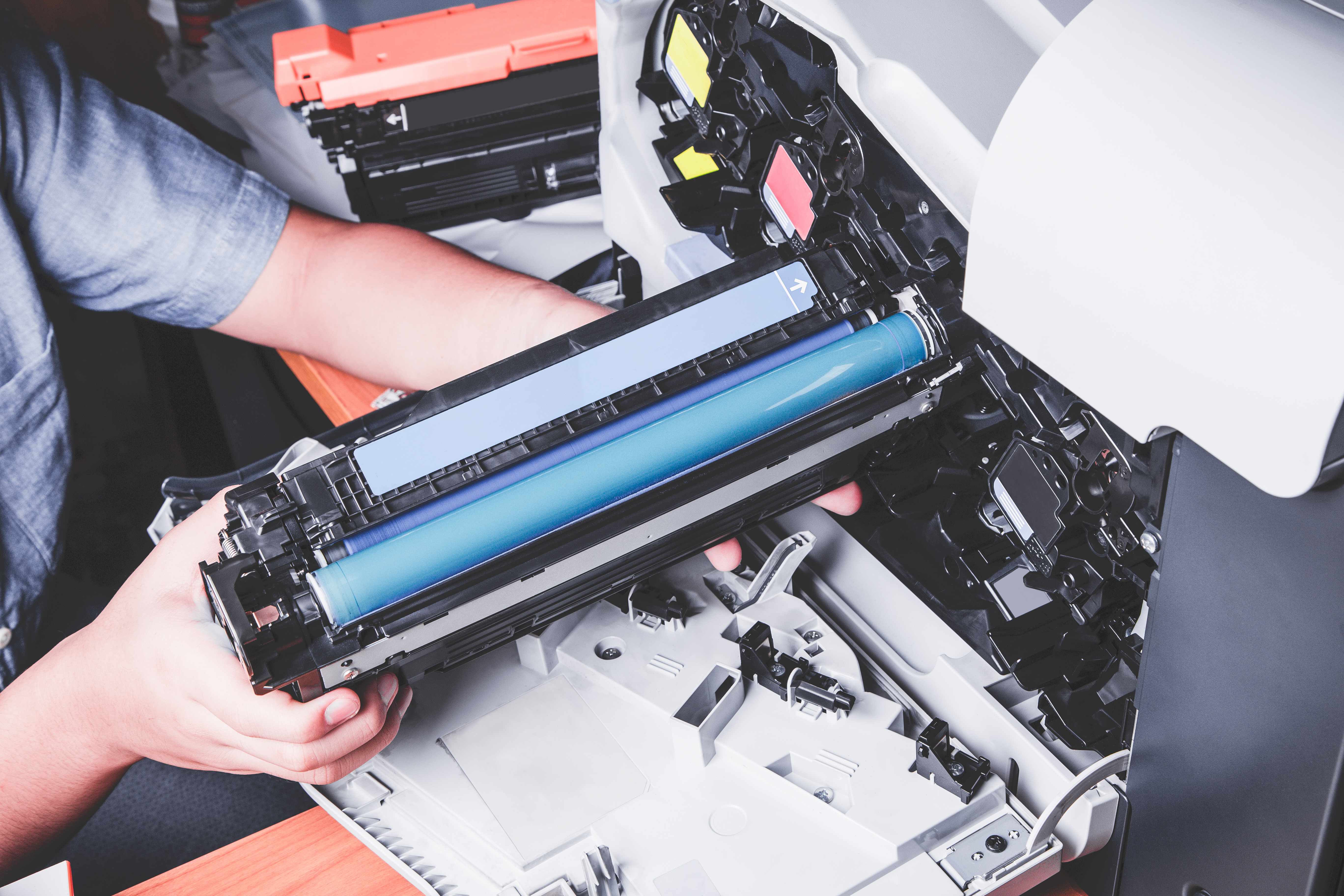 Professional technician performing expert printer and copier repair services with toner cartridge replacement in modern Saskatoon business environment showcasing Vonex technical expertise and genuine parts inventory